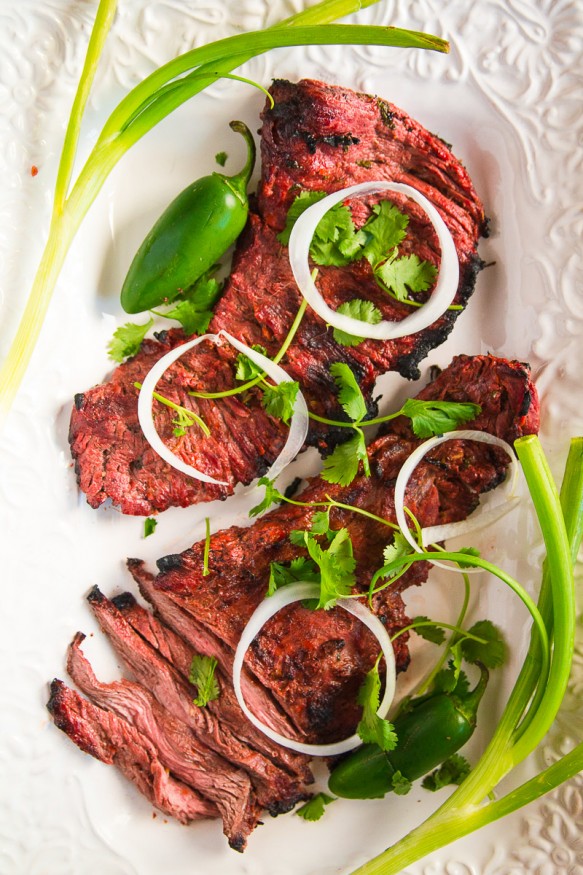 This carne asada beer marinade recipe uses a light beer and fresh citrus ingredients, with some heat and smokiness using cayenne jalapeno and smoked paprika.