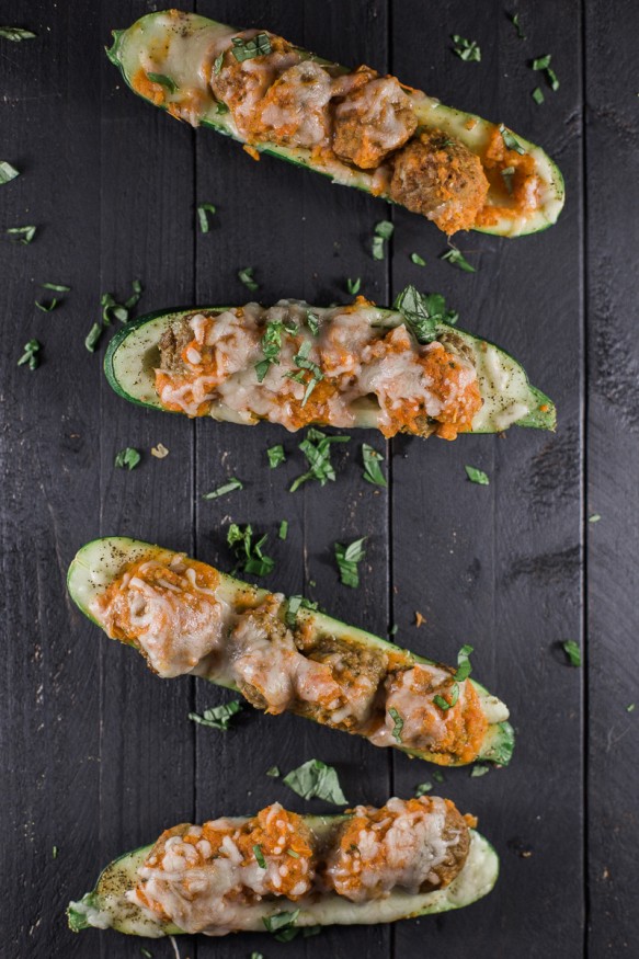 Zucchini boats topped with a quick and simple marinara made from fresh tomatoes, mozzarella, and Personal Trainer Food Meatballs