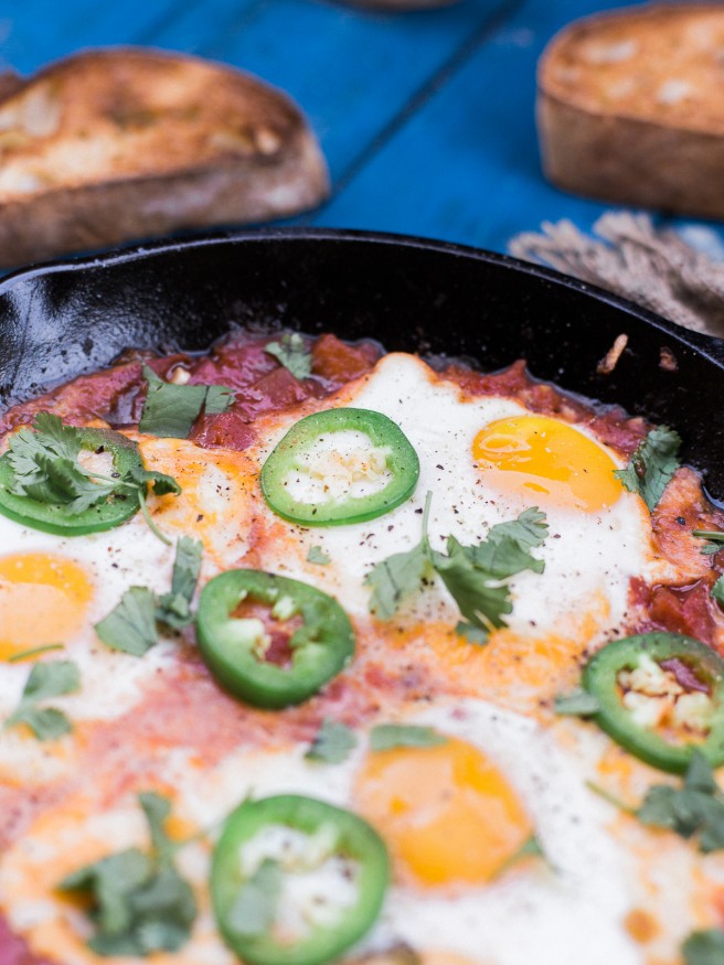 Eggs In Hell with some spice! Jalapeños added to diced tomatoes onions and garlic, topped with cheese and eggs. This is the ultimate comfort food! 