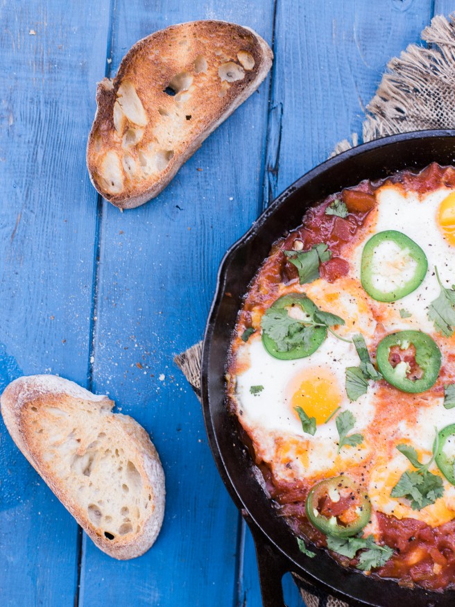 Eggs In Hell with some spice! Jalapeños added to diced tomatoes onions and garlic, topped with cheese and eggs. This is the ultimate comfort food! 