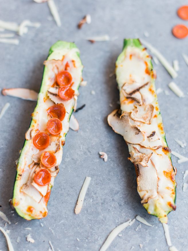 Zucchini boats on the grill with pizza toppings?! Loaded with mozzarella, pepperoni mushrooms and marinara sauce, these pizza zucchini boats are amazing!