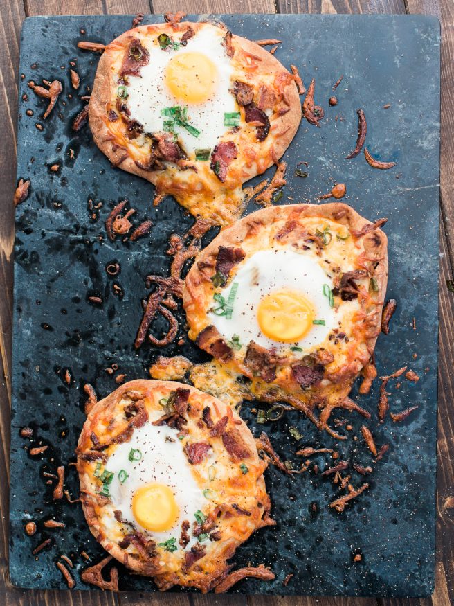 Breakfast pizza using Naan bread, loaded with cheese, bacon and topped with an egg! Hits the spot every morning!! 