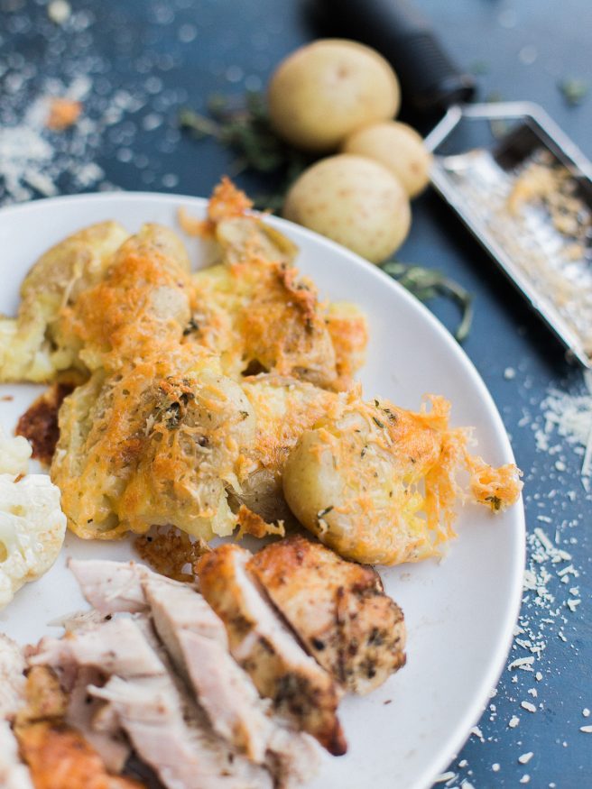 Smashed Potatoes smothered in a herb garlic butter with parmesan and cheddar cheese. Perfect comfort food side and is the best smashed potato recipe ever! 