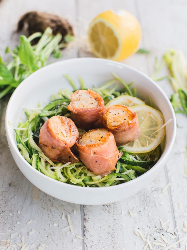 Prosciutto Wrapped scallops served on Basil Parmesan Zoodles, this dish is light and fresh, and is full of flavor! 