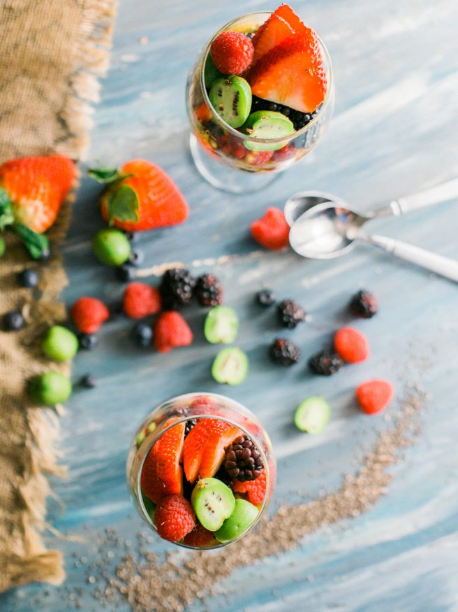 Chia parfait with a chia pudding and vanilla greek yogurt. Topped with honey, baby kiwis, and other fresh fruits. Makes a great quick and healthy breakfast!