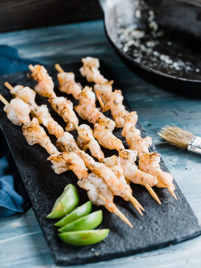 Grilled shrimp recipe with a garlic and herb butter. Insanely easy, delicious and perfect for summer grill outs! 