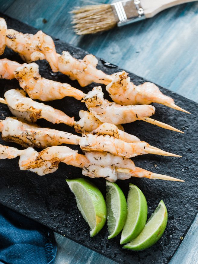 Grilled shrimp recipe with a garlic and herb butter. Insanely easy, delicious and perfect for summer grill outs! 