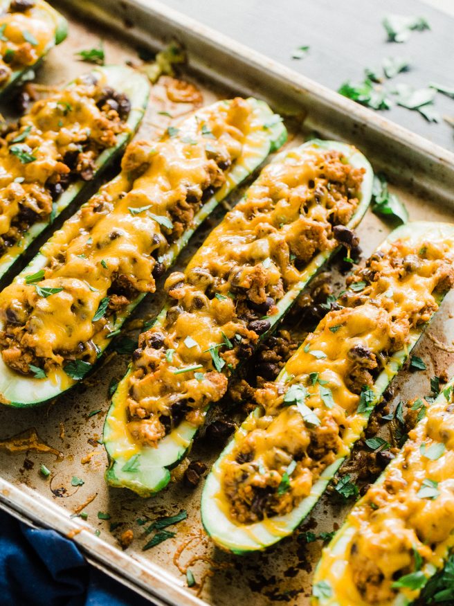 Stuffed Zucchini Boats with a ground turkey filling. Turkey simmered with salsa, Mexican inspired seasoning, and black beans, topped with melted cheese!