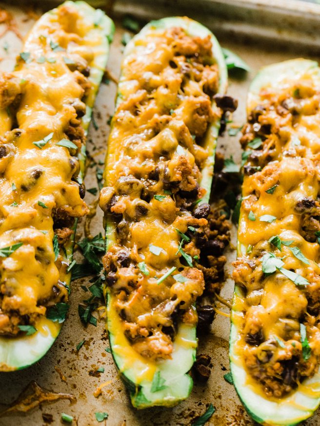 Stuffed Zucchini Boats with a ground turkey filling. Turkey simmered with salsa, Mexican inspired seasoning, and black beans, topped with melted cheese!