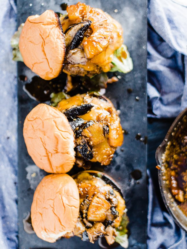 Teriyaki Burger topped with a Grilled pineapple, portabella mushroom, simmering in teriyaki sauce and topped on toasted Hawaiian hamburger rolls. 