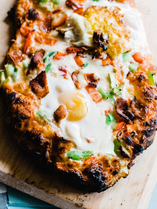 Breakfast Pizza meets Denver omelette. Topped with egg, bacon, bell peppers and cheese. A great way to start the weekend is with a breakfast pizza! 