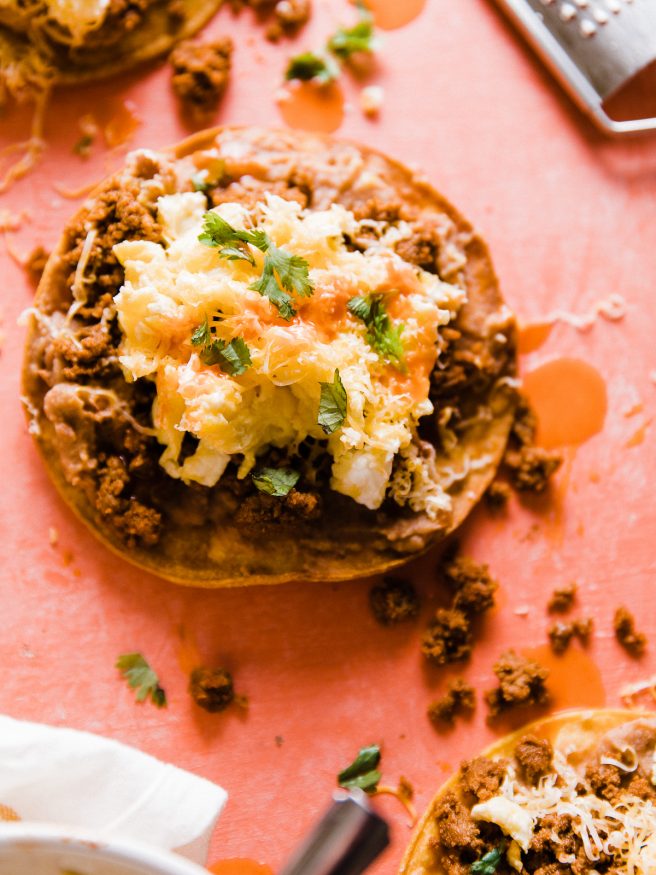 This Breakfast Tostada is loaded up with chorizo seasoned turkey, refried beans, scrambled eggs and cheese. The perfect way to start the day. SUPER EASY TO MAKE!