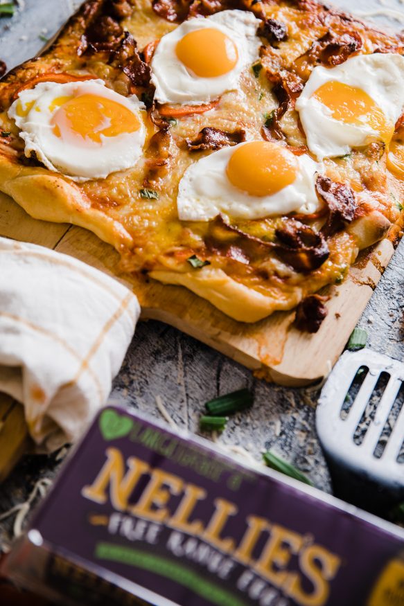 A delicious breakfast pizza loaded with bacon sausage, onion and red bell pepper, then topped with sunny side up eggs. Great weekend breakfast or a breakfast for dinner meal! 