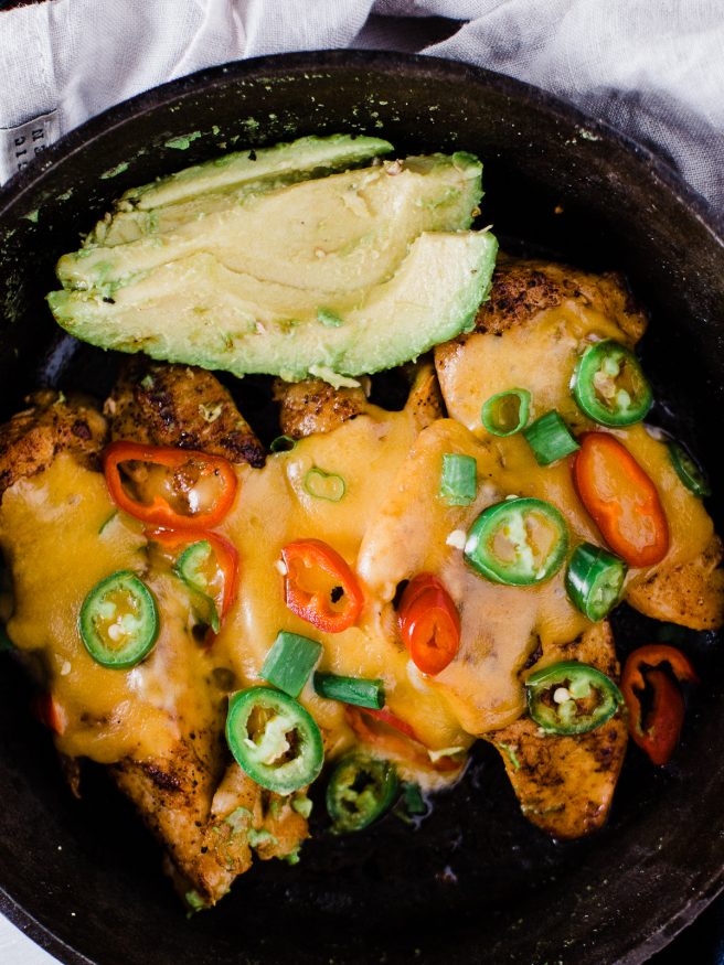 Spicy Skillet Chicken Tenders flambeed in tequila. Makes a great quick dinner, full of heat from fresno and serrano peppers and loaded with melted cheese on top! 