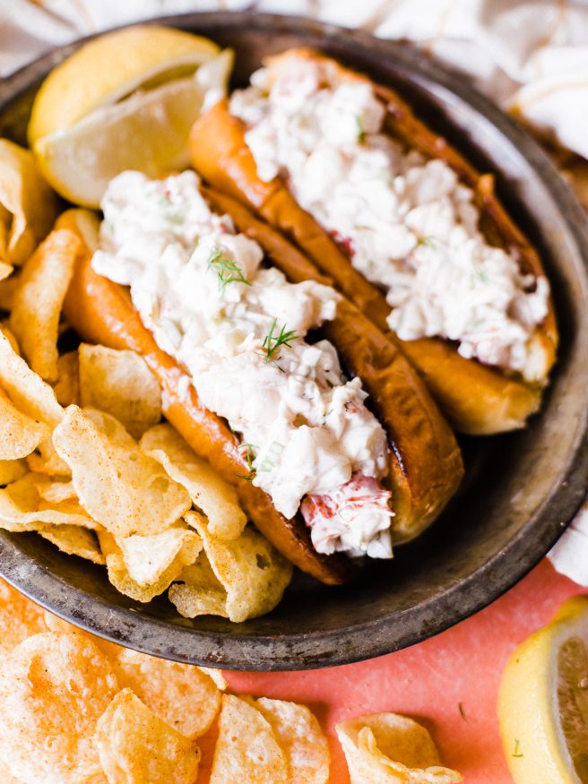 Smoked lobster roll with old bay seasoned chips is the best way to enjoy the summer! Smoked  lobster on a traeger grill and loaded on toasted brioche buns. 