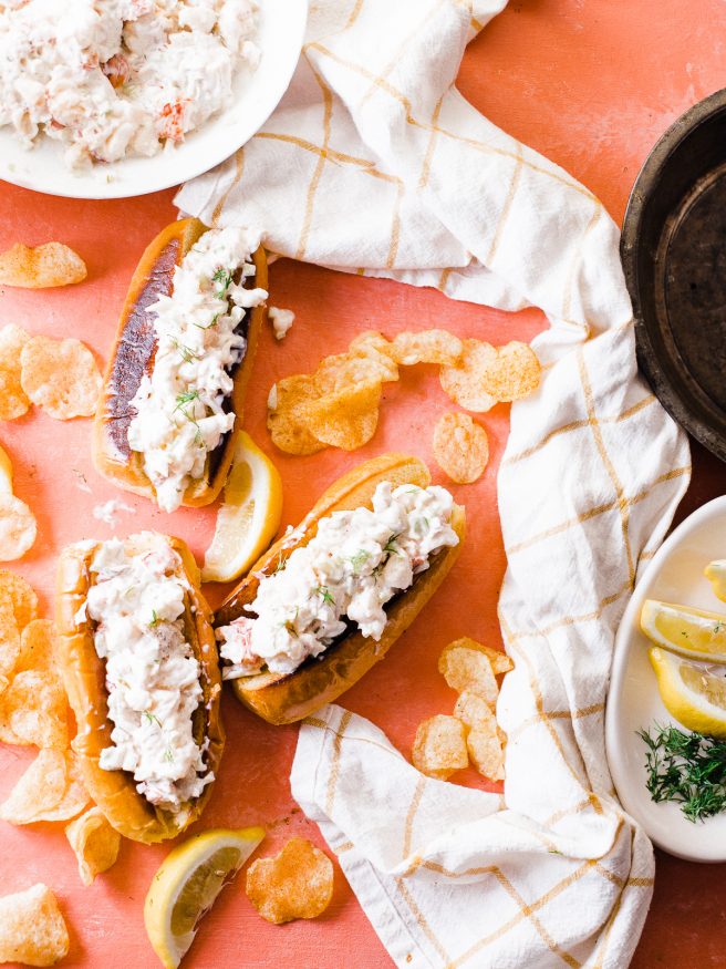 Smoked lobster roll with old bay seasoned chips is the best way to enjoy the summer! Smoked  lobster on a traeger grill and loaded on toasted brioche buns. 