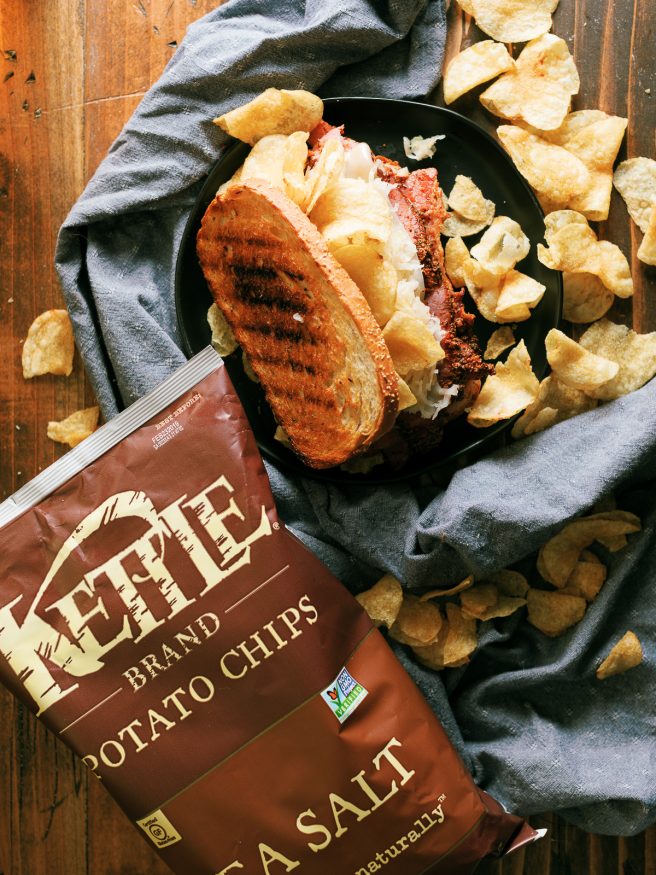 A Pastrami Reuben grilled on a panini press with crunchy kettle cooked chips. My absolute favorite way to do pastrami sandwiches!