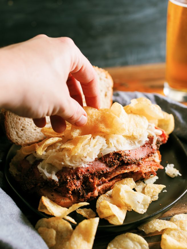 A Pastrami Reuben grilled on a panini press with crunchy kettle cooked chips. My absolute favorite way to do pastrami sandwiches!