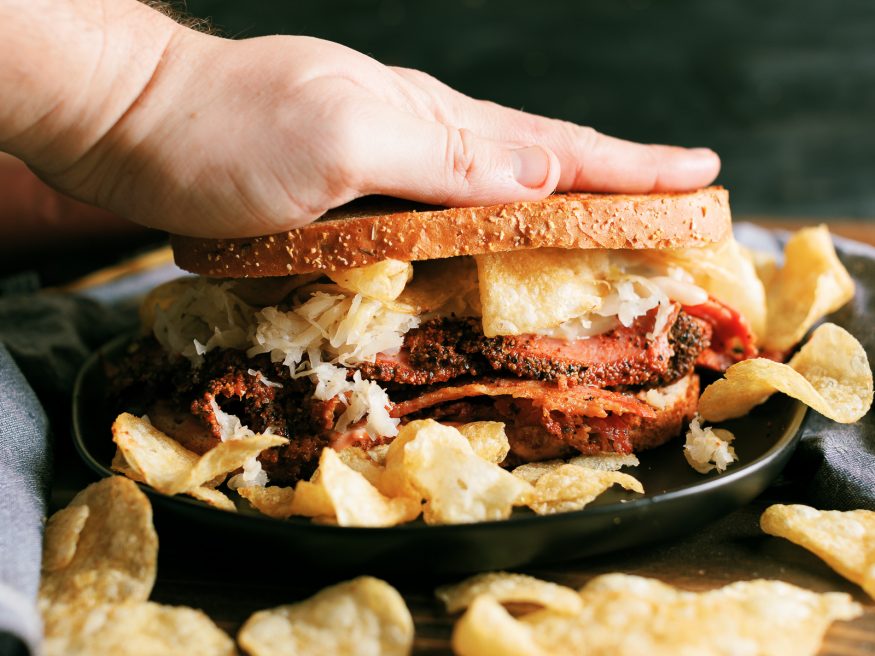 A Pastrami Reuben grilled on a panini press with crunchy kettle cooked chips. My absolute favorite way to do pastrami sandwiches!