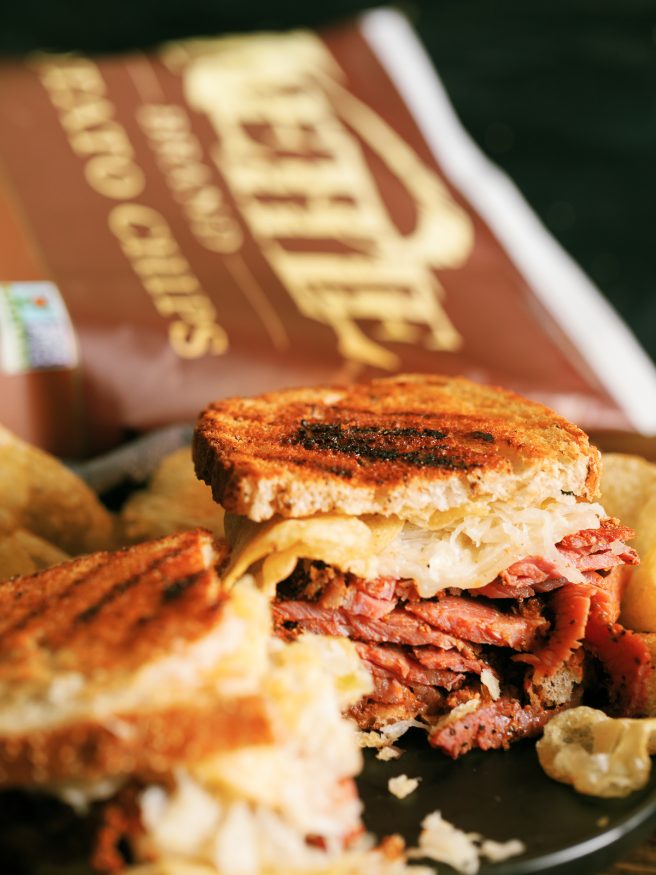 A Pastrami Reuben grilled on a panini press with crunchy kettle cooked chips. My absolute favorite way to do pastrami sandwiches!