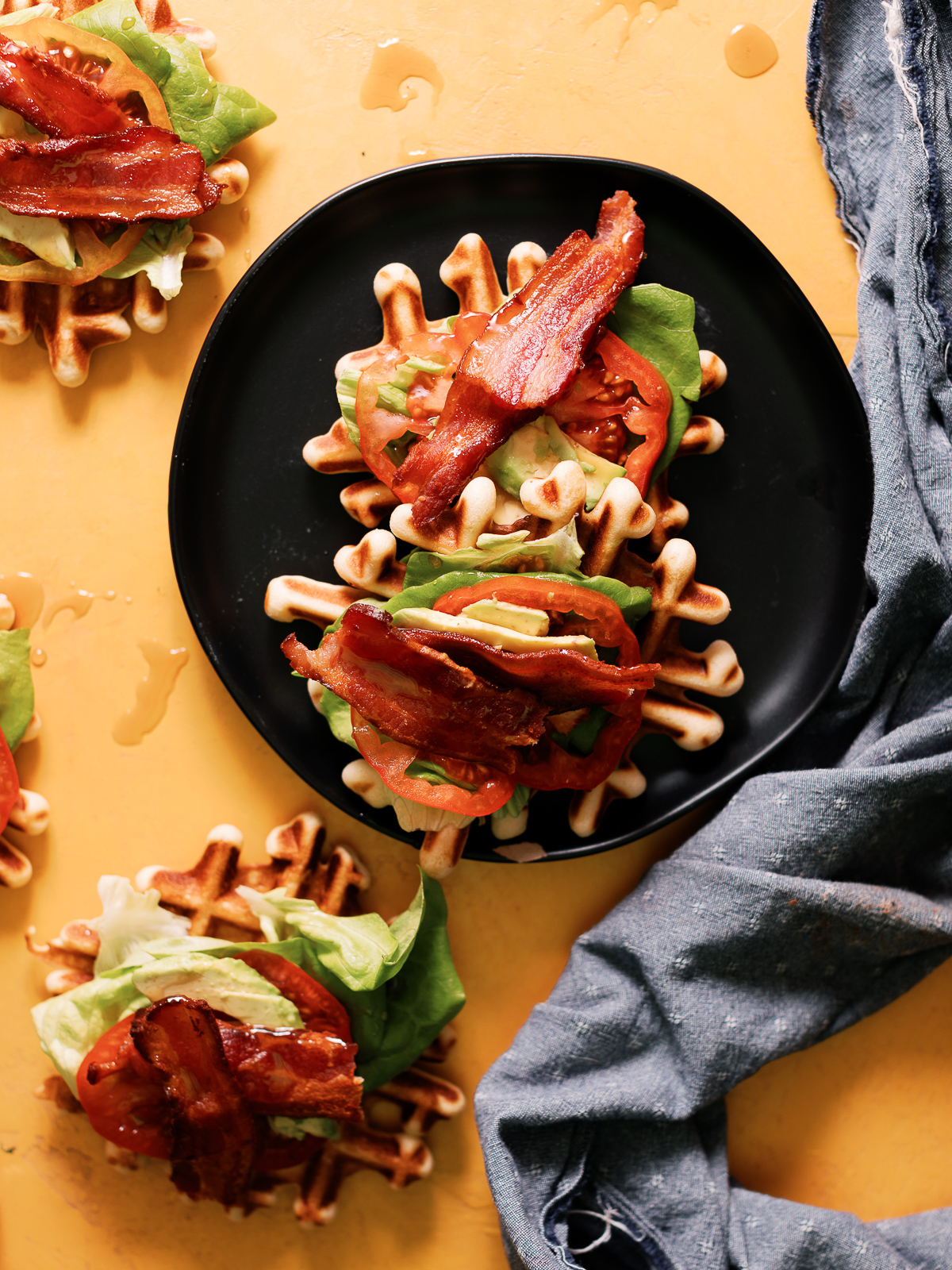 BLT Waffles bites combine the best of both worlds. Smothered with maple syrup to make this an awesome way to enjoy your next game day!