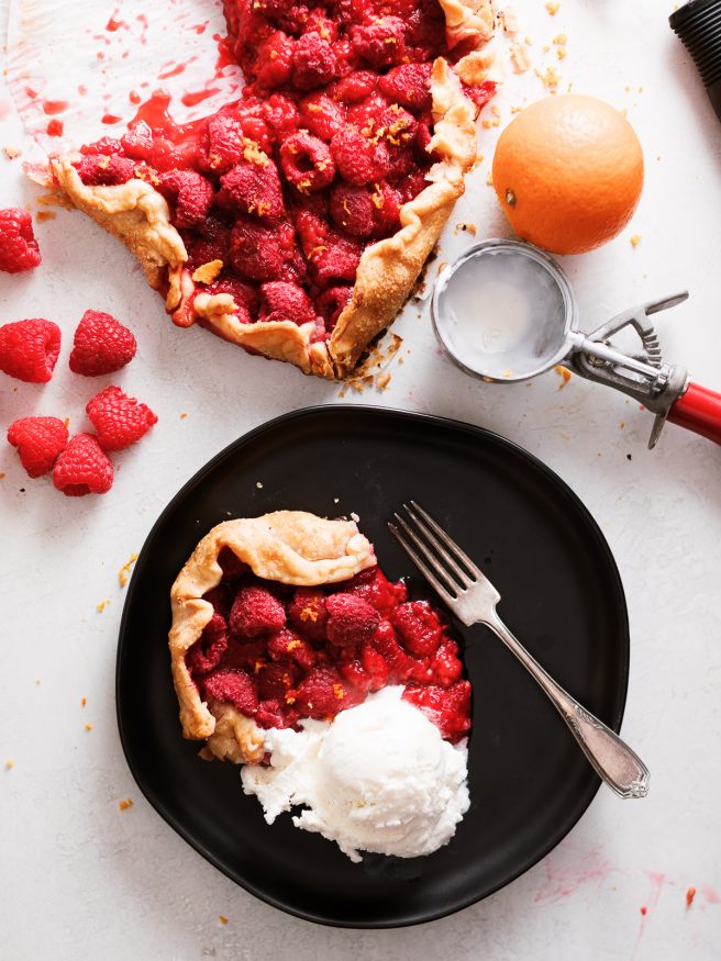 A raspberry galette in the shape of a heart. With raspberries, orange zest and a pre-made pie crust this makes the perfect Valentines Day dessert!