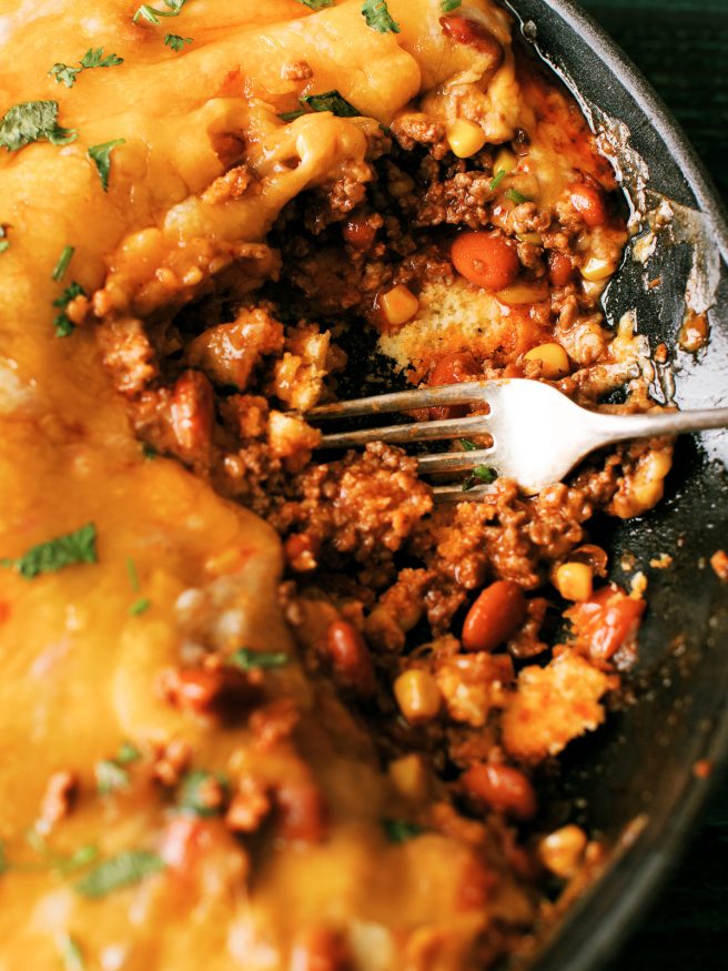 Tamale Pie is perfect comfort food! Ground beef beans,fire roasted corn with a taco seasoning, on top of cornbread and loaded with cheese.