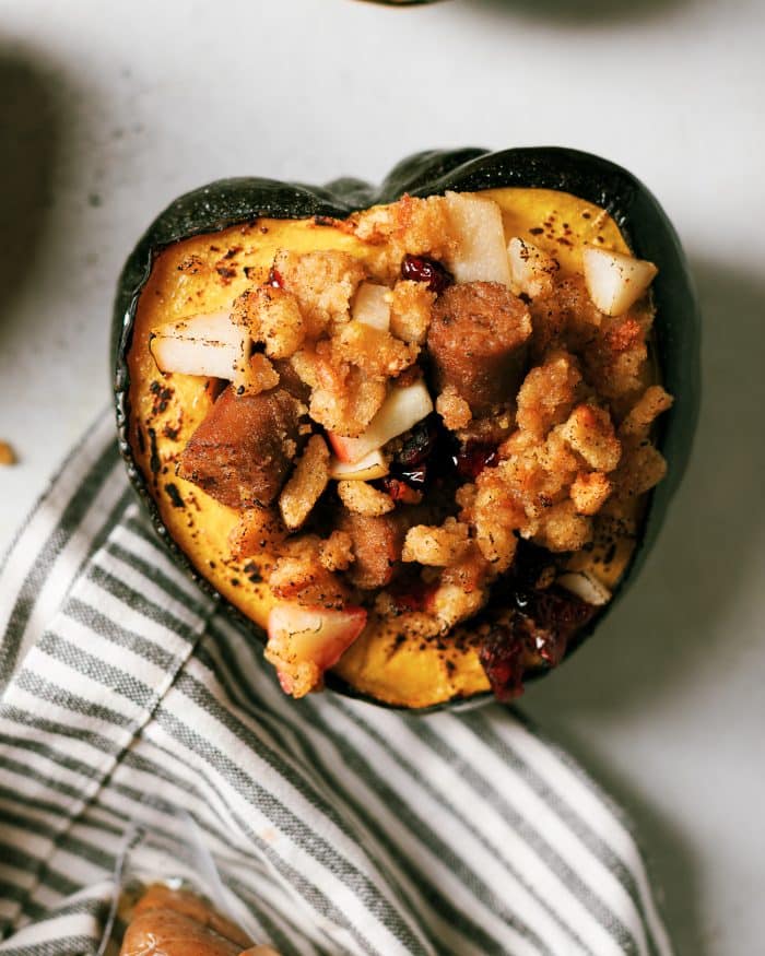 Roasted Acorn Squash with a sweet and savory breakfast  stuffing that is plant-based. Easily interchangeable with meat proteins to make this perfect everyone