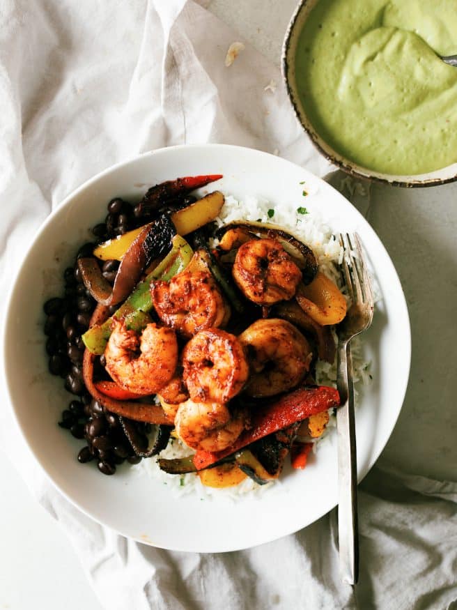 
Shrimp Fajitas on a rice bowl with a little tequila and lime to jazz things up. Topped with an optional spicy avocado crema that will make your taste buds dance!