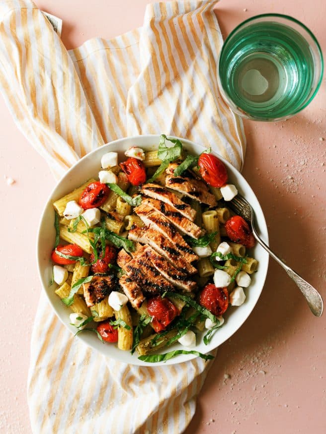 Grilled Chicken Caprese Pasta with a basil pesto and quick balsamic vinaigrette glazed chicken breast makes a quick dinner that can be done in 30 minutes. 