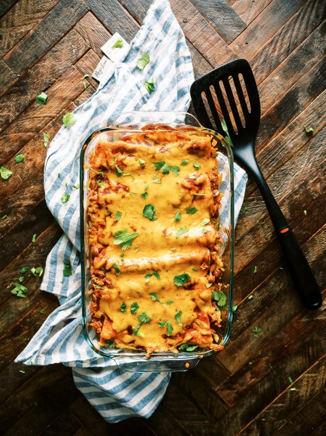 This Bean Rice and Cheese Enchilada is an awesome way to change up enchilada night. With a from scratch sauce and quick rice cooker spanish rice recipe all in one!