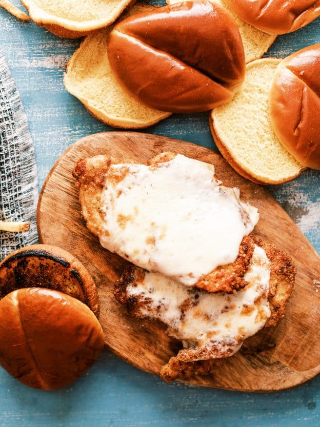 Chicken Parmesan Sandwiches in the theme of a burger. They're a delicious way to change up your chicken Parmesan and so fun to eat!
