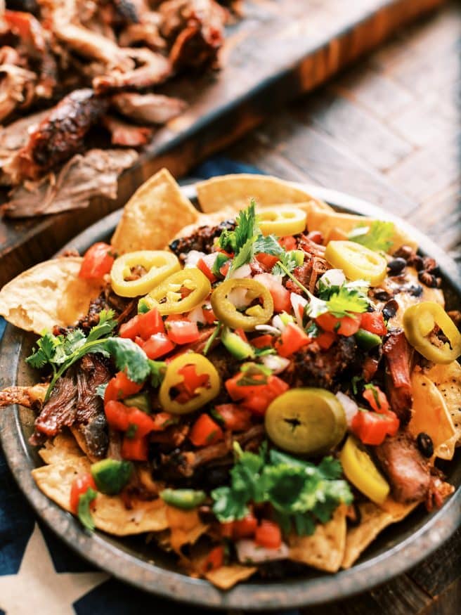 Texas Style Pulled Pork Nachos. Smoked Pulled Pork shoulder on top of cheesy nachos is the best way to spend your weekend.