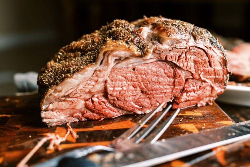 Prime Rib roast with a black truffle sea salt and herb rub that is so juicy tender and full of flavor you'll want to make this every year!