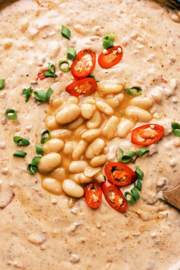 This white bean queso dip is loaded with all sorts of goodness. White Chili Beans , ground beef and all sorts of cheese. It’s got tailgating vibes all over it!  