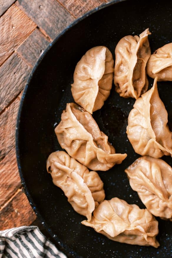 Fried Pork dumplings with a delicious pork filling with ginger, soy sauce rice vinegar, scallions and cabbage and from scratch dough.