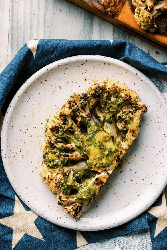 grilled chimichurri cauliflower with a quick chimichurri sauce, marinated cauliflower, then grilled. Perfect keto side!